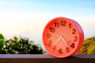 alarm clock on natural landscape season park