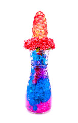 Beautiful flowers in glass bottle with hydrogel isolated on whit