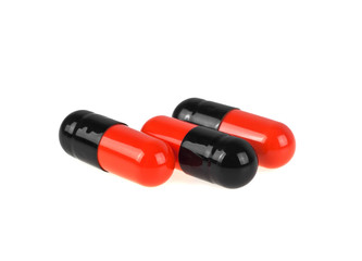 Pills. Tablets. Capsule. Close-up of pile of black and red table