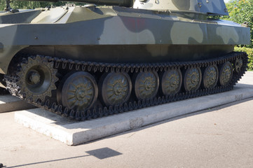 Fototapeta na wymiar Tracks and wheels of military equipment. Exhibited on a plinth military equipment.