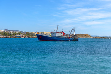 Traditional fishing boat in Chora, Naxos. Summer in Greece.