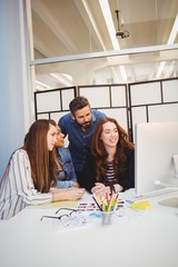 Business people using computer in meeting room 