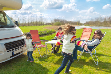 Family vacation, RV (camper) travel with kids, happy parents with children on holiday trip in...