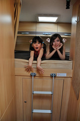 Family vacation, RV holiday trip, camping. Happy smiling kids travel on camper. Children in motorhome interior
