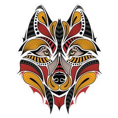 Patterned colored head of the wolf. African / indian / totem / tattoo design. It may be used for design of a t-shirt, bag, postcard and poster.