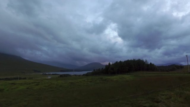 The view out of a car window while driving through the Black Mount with Loch Tulla in the distance. Scottish Highlands.