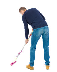 Back view of a man washing floor mop. He is busy cleaning. Rear view people collection.  backside view of person.  Isolated over white background. Man in warm jacket washing floor mop