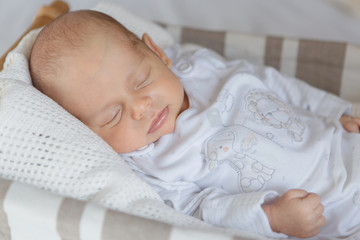 Newborn baby boy lying in a basket

