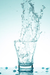 Fototapeta na wymiar water splash in glasses isolated on white