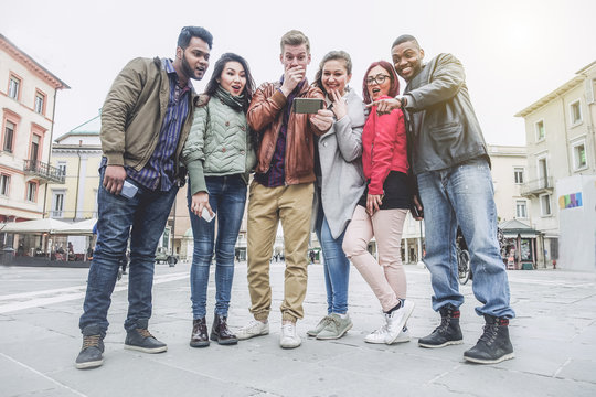 Multiracial group of people looking surprised smartphone 