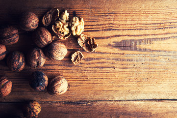 Walnuts on wooden background. Copyspace