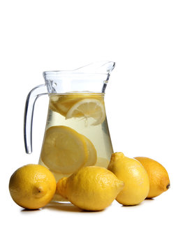 Water and lemon in a glass on a white background