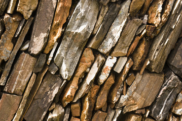 A close up image of an almost vertical dry stone wall