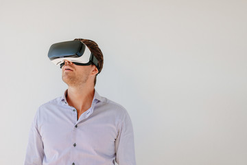 Man with VR headset looking away at the objects