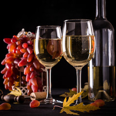 White wine still life in vintage style on black background