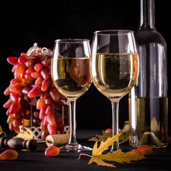 White wine still life in vintage style on black background
