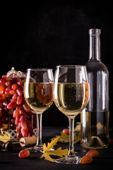 White wine still life in vintage style on black background