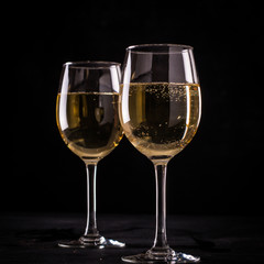 White wine still life in vintage style on black background