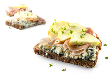 Sandwiches from whole grain with blue cheese, prosciutto ham and apple slices