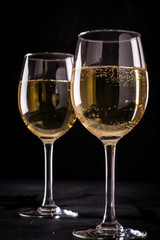 White wine still life in vintage style on black background