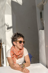 Young beautiful woman in the narrow streets of Chora Naxos, Cycl