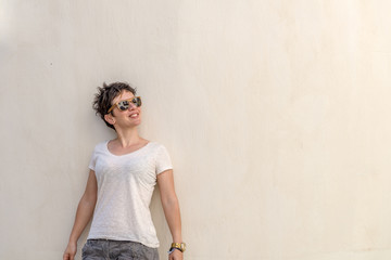 Fototapeta premium Young beautiful woman in the narrow streets of Chora Naxos, Cycl