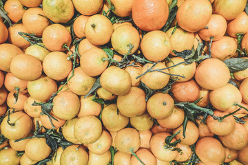Bunch of fresh bio tangerines oranges on market - Organic season fruit