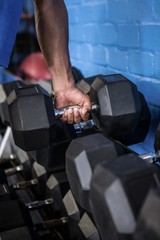 Man exercising with dumbbell in gym