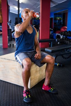 Male Athlete Drinking Juice In Gym