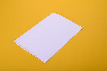 white paper bifold brochure mockup on yellow background