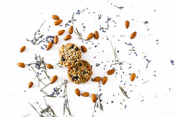 Grain cookies and almonds with lavender petals on a white background