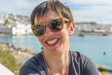 Young beautiful woman enjoying the view at Mykonos port, Cyclade