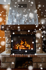 close up of burning fireplace with snow