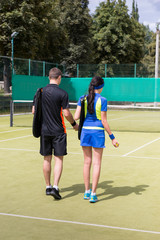 Obraz premium View from the back on a couple of tennis players