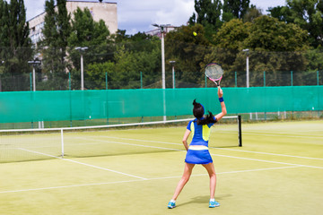 Woman tennis player in action on a court outdoor