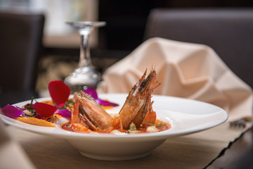 Cooked Black Tiger Shrimp in white plate on restaurant table