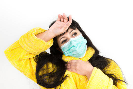 Symptoms and treatment of colds, influenza, fever. Treatment of allergy. A cold woman sneezing into a handkerchief on a white background.