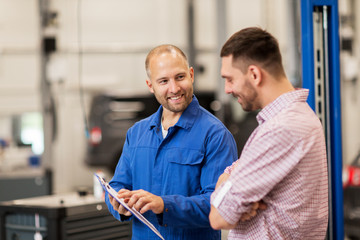 auto mechanic with clipboard and man at car shop