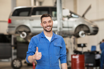 happy auto mechanic man or smith at car workshop - Powered by Adobe
