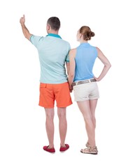 young couple pointing at wal Back view  (woman and man). Rear view people collection.  backside view of person.  Isolated over white background.