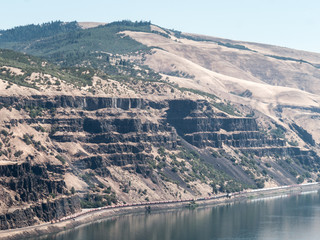 Long cargo train making its way along the Columbia River Gorge