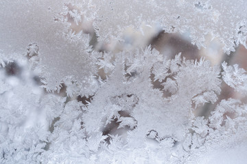 Fantasy openwork frosty pattern on window glass.