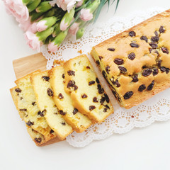 Home made raisins sponge cake and pink flowers