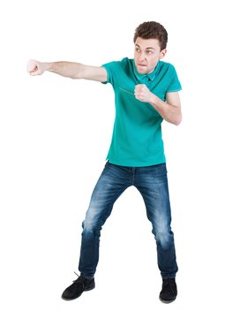 back view of skinny guy funny fights waving his arms and legs. Isolated over white background. Rear view people collection.  The guy in the green shirt waving fists.