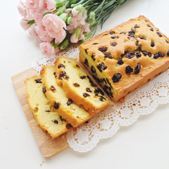 Home made raisins sponge cake and pink flowers