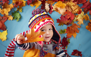 two years old boy dreaming in autumn