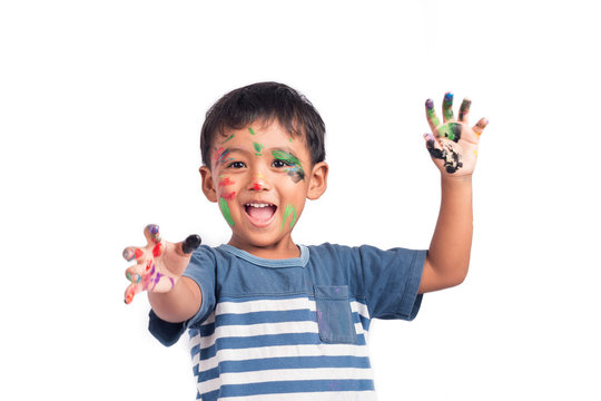 Cute child asian little boy playing water color and paint on fac