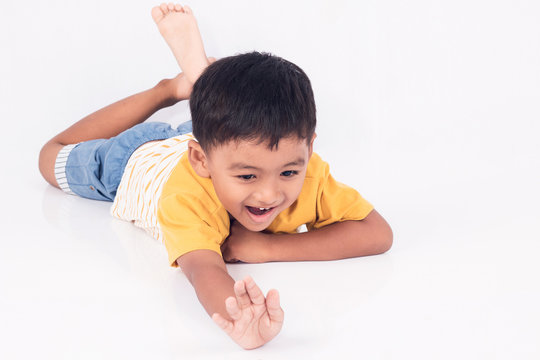 Cute child asian little boy smile and laying on floor