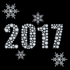 The new 2017 year diamond on a black background and snowflakes