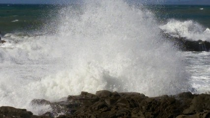 Ocean surf splashing rocks